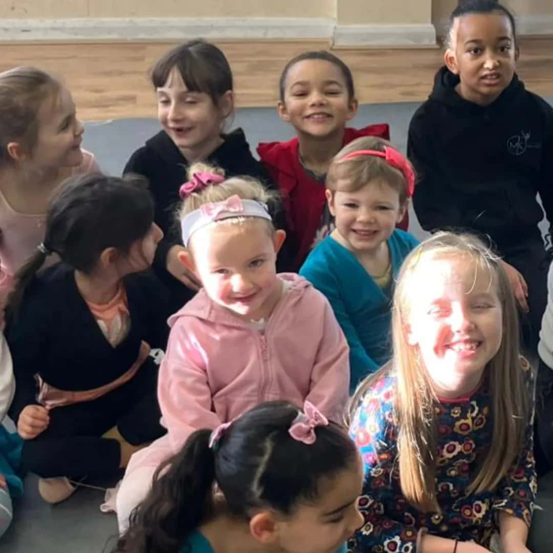 A group of smiling children in the dance studio