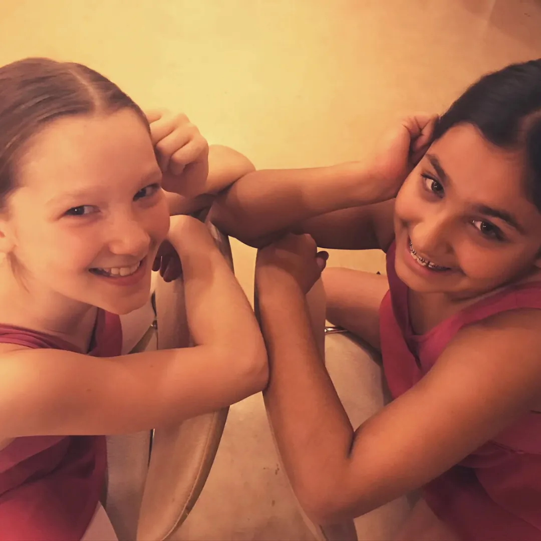 Two smiling girls who have made friends at MK Dance
