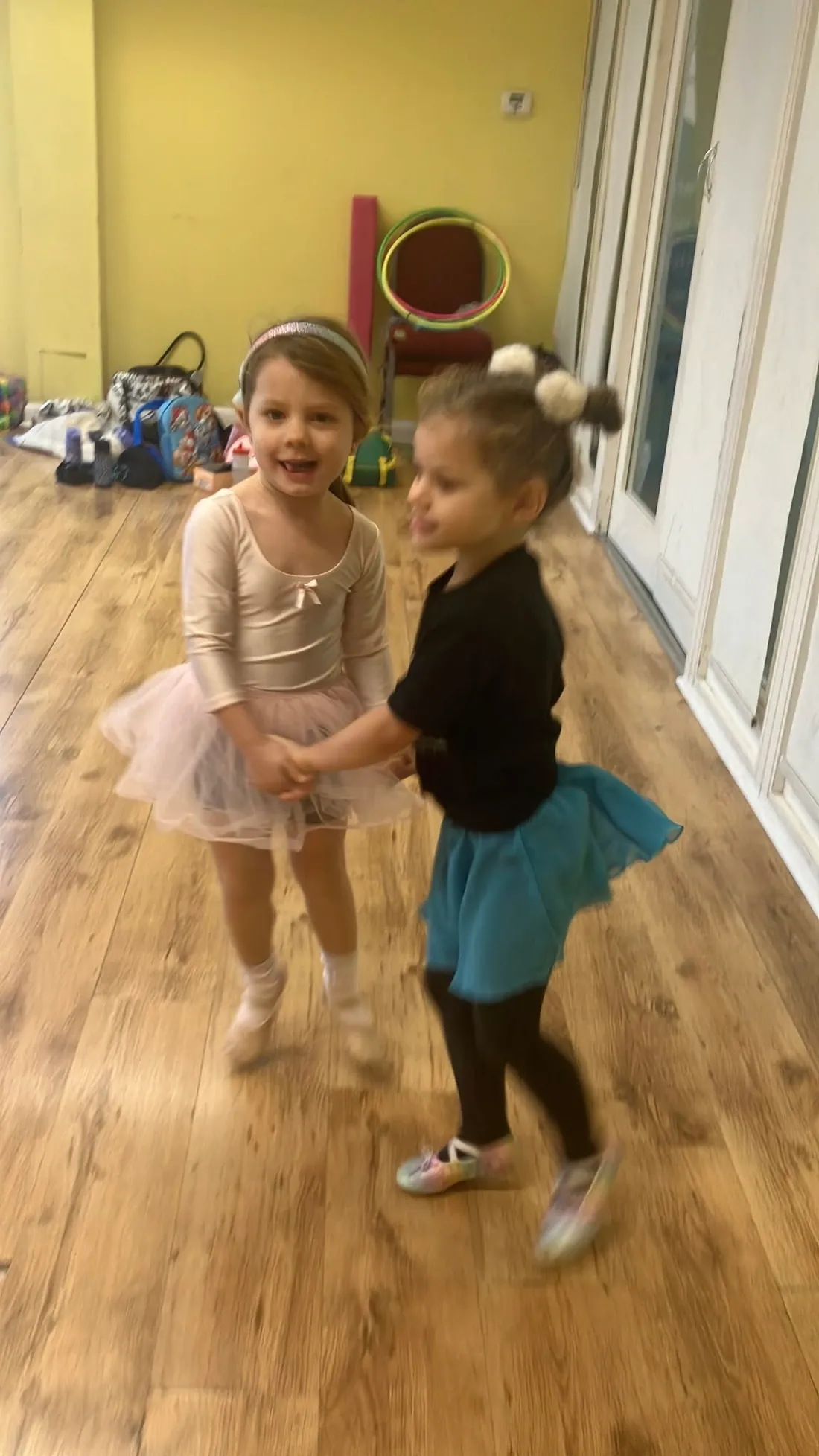 Two small children dancing together in the studio