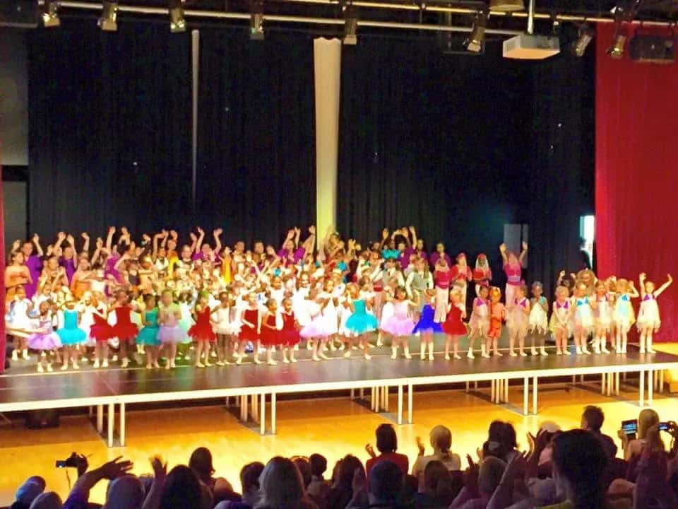 The full cast on stage for the show finale, with the audience in view