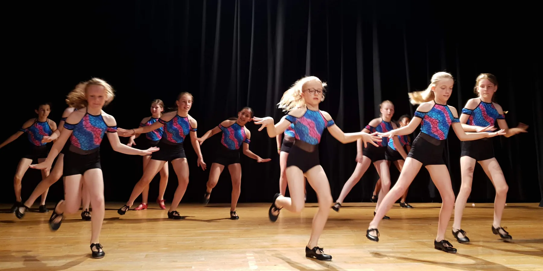 A line of tap dancers performing on stage